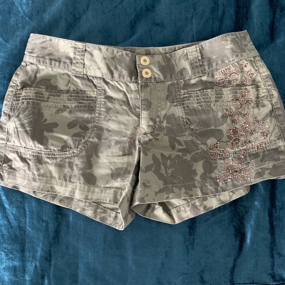 Express army floral shorts with gold glitter.